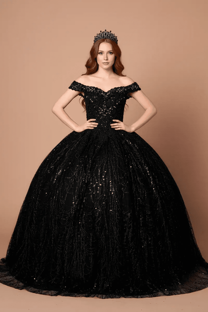 Front-Facing of a woman wearing Black formal gown featuring open back design sweeping hemline and attached cape detail