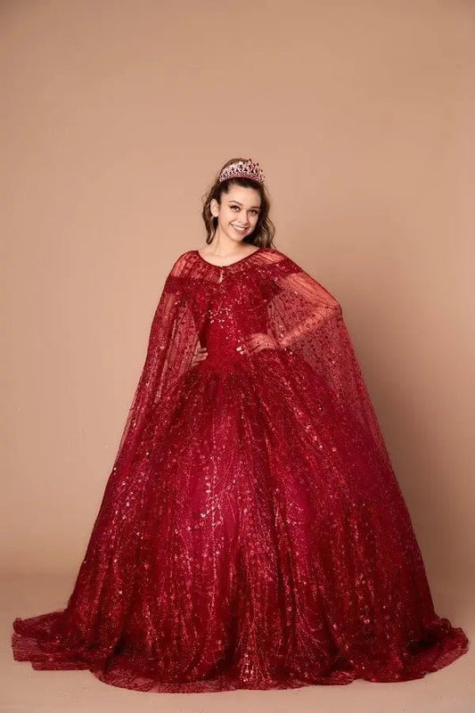 Front-Facing of a woman wearing Burgundy ball gown with off-shoulder neckline glittering sequins and full flowing skirt with elegant cape