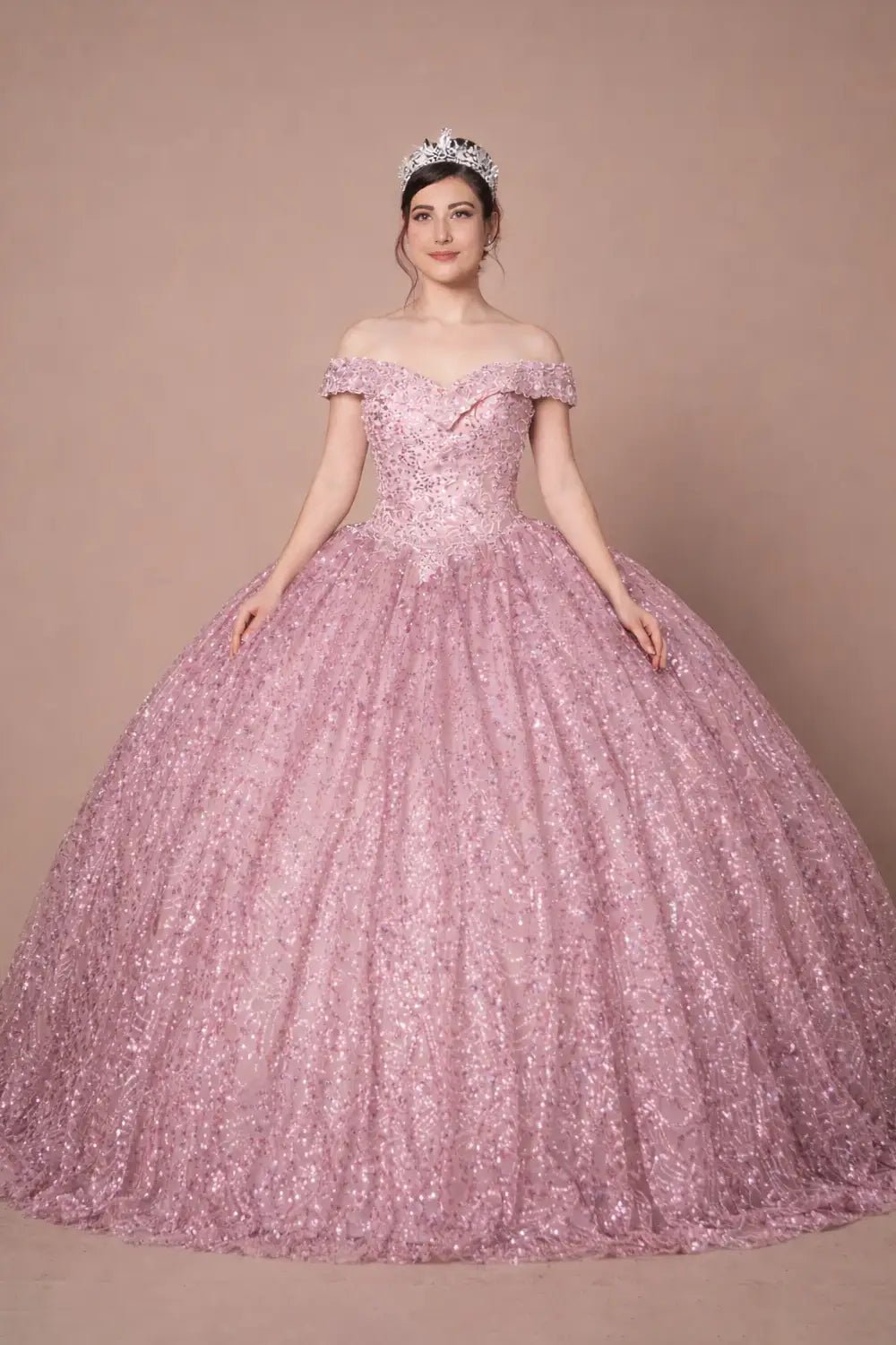 Front-Facing of a woman wearing Dusty rose ball gown with off-shoulder neckline subtle sequins and flowing skirt complemented by cape