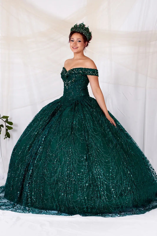 Side View of a woman wearing Rich green evening dress with shimmering sequins soft off-shoulder sleeves and fluid silhouette enhanced by cape