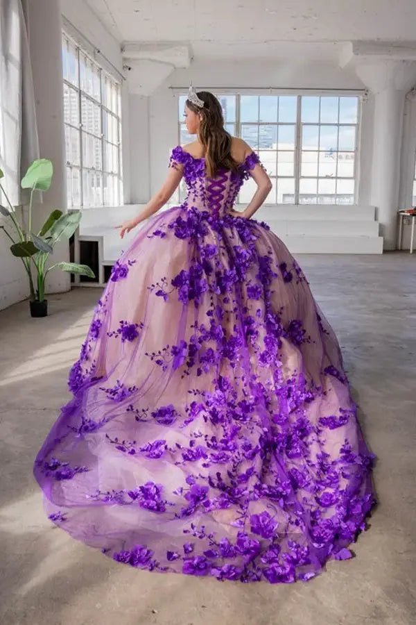 Back-Facing of a woman wearing Purple formal gown featuring long trailing tail layered skirt and flowing silhouette
