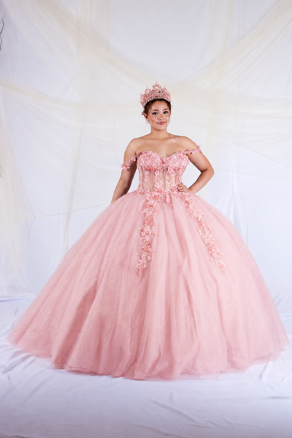 Bubble Pink quinceañera dress showcases detachable sheer cape sleeves above floral appliqué corset bodice.
