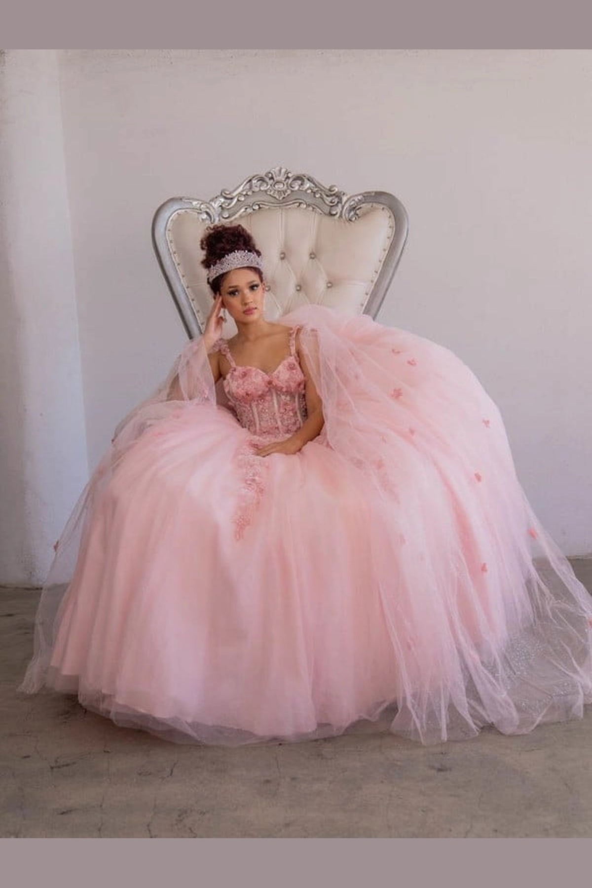 Detachable sheer cape sleeves defines the Bubble Pink quinceañera dress in this detailed view.