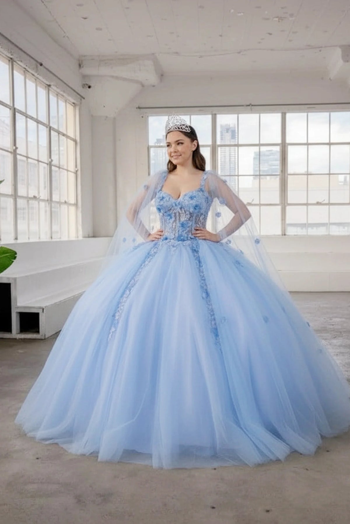 Across this Light Blue quinceañera ball gown, the image highlights floral appliqué corset bodice from an alternate angle.
