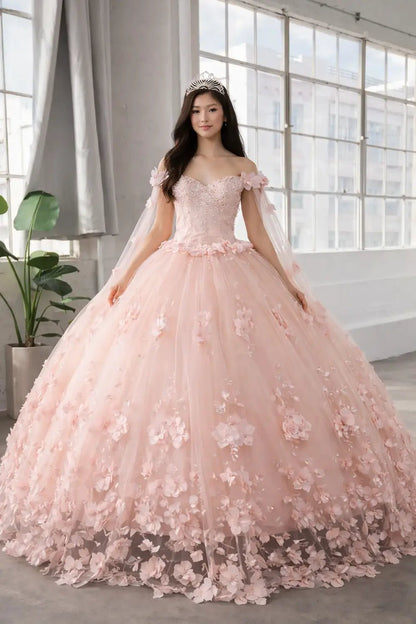 Front-Facing of a woman wearing Blush pink ball gown with two-tone styling floral embellishment and removable shoulder cape with full skirt