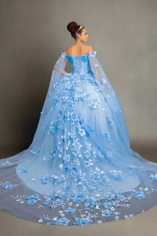 Back-Facing of a woman wearing Light blue formal dress featuring layered skirt open back and detachable cape accent