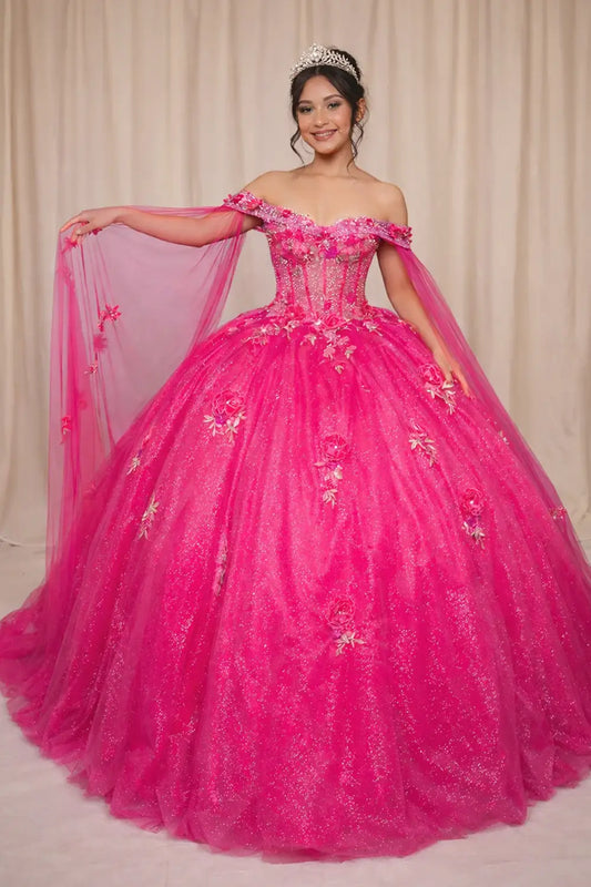 Front-Facing of a woman wearing Hot pink quinceanera gown with sheer lace bodice off-shoulder neckline and flowing skirt with removable shoulder cape