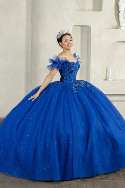 Front-Facing of a woman wearing Royal blue ball gown with beaded embroidered bodice removable ruffle off-shoulder sleeves and full glitter tulle skirt with cape detail