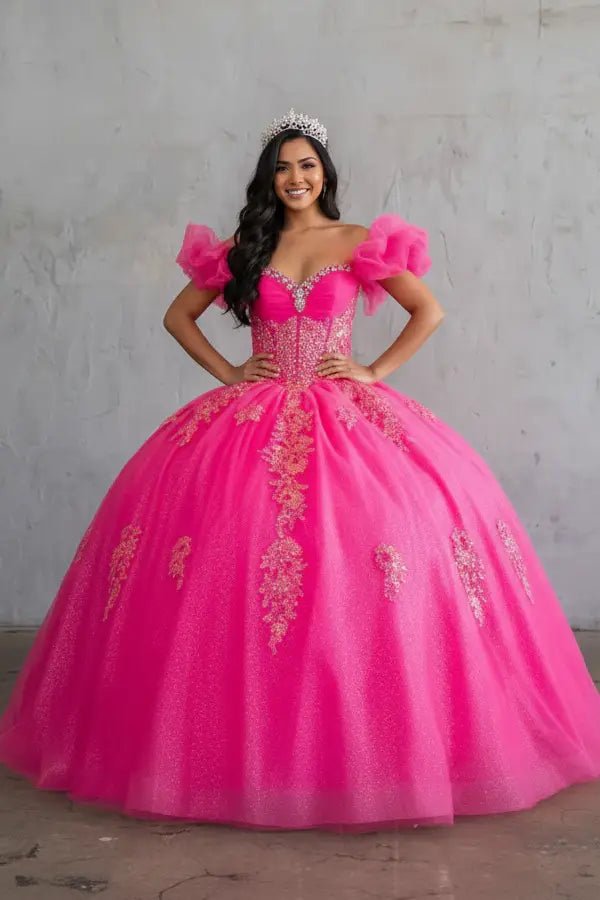 Front-Facing of a woman wearing Hot pink ball gown with illusion sweetheart neckline structured corset bodice and ruffled off-shoulder straps flowing into a floor-length A-line skirt