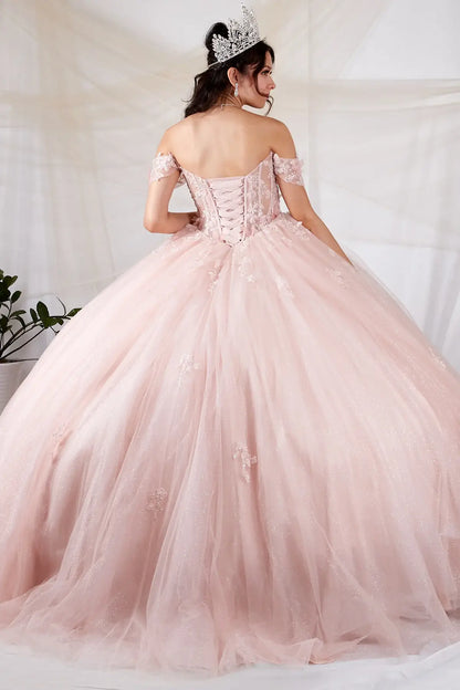 Back-Facing of a woman wearing Blush formal gown featuring structured back flowing glitter skirt and soft silhouette