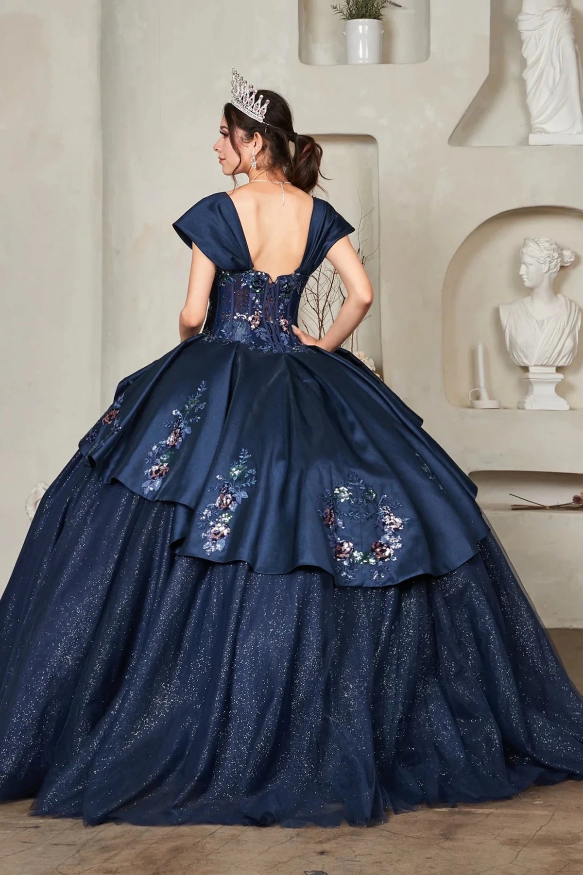 From behind, the Navy quinceañera ball gown reveals a shaped lace-up back and the sweep of the full skirt.