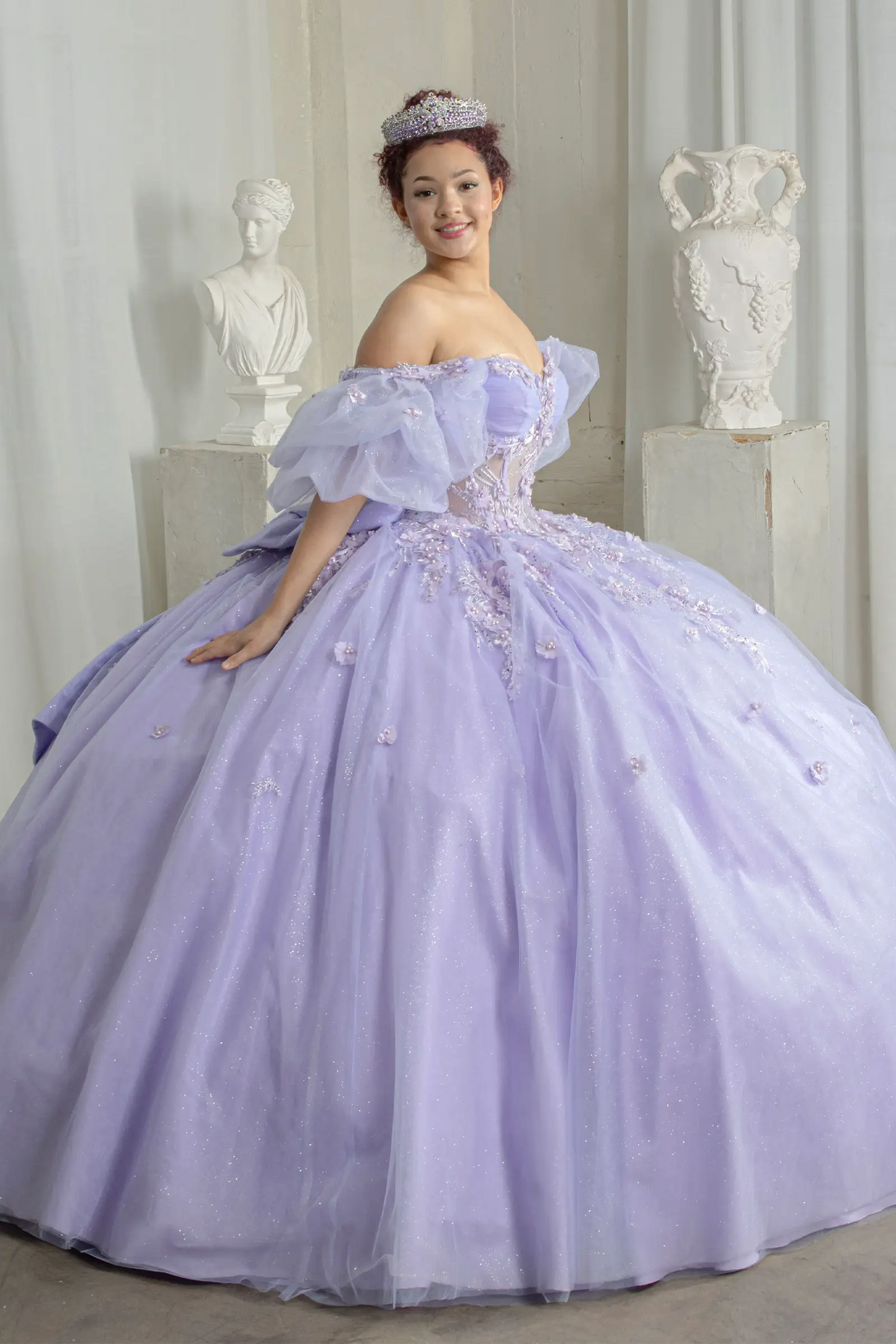 Side View of a woman wearing Soft purple gown with sheer bodice butterfly details and multi-layer lace design
