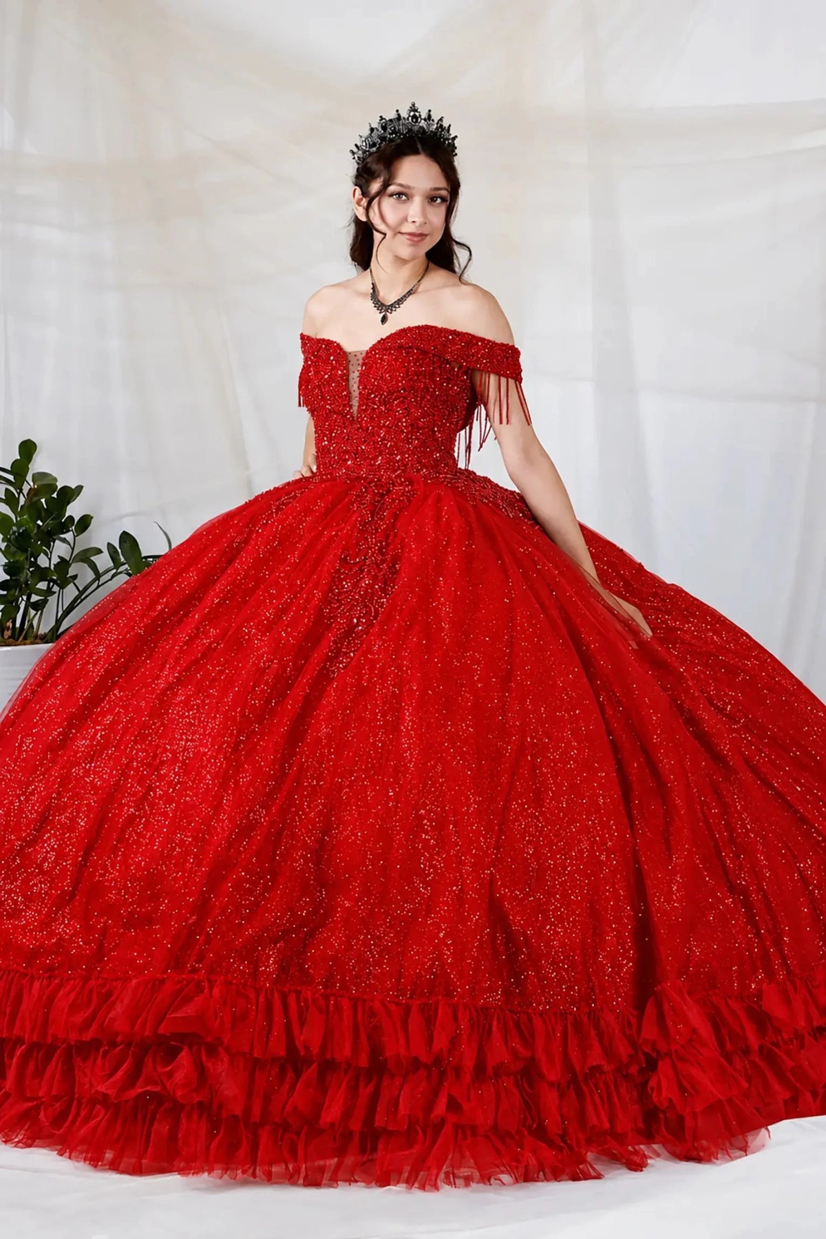 Red quinceañera ball gown with rhinestone beaded bodice, ruffled hem and glitter tulle skirt