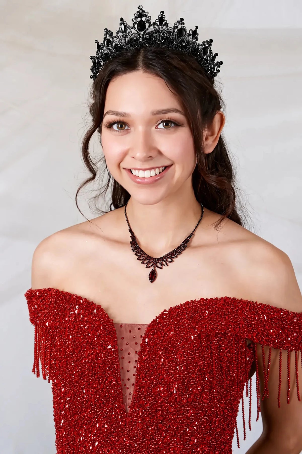 Red quinceañera ball gown with rhinestone beaded bodice, tiered ruffle hem and glitter tulle skirt