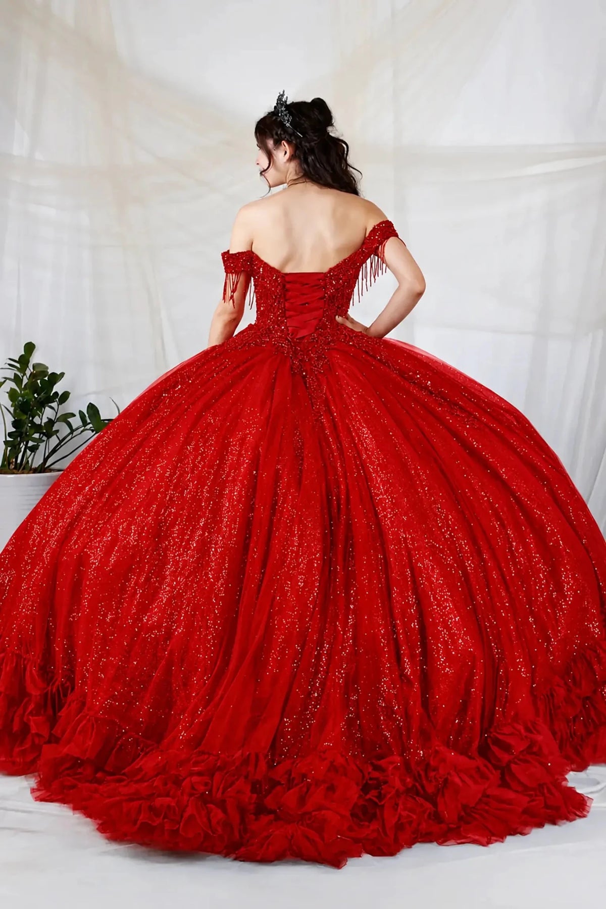 Red quinceañera ball gown with rhinestone beaded bodice, tiered ruffle hem and glitter tulle skirt