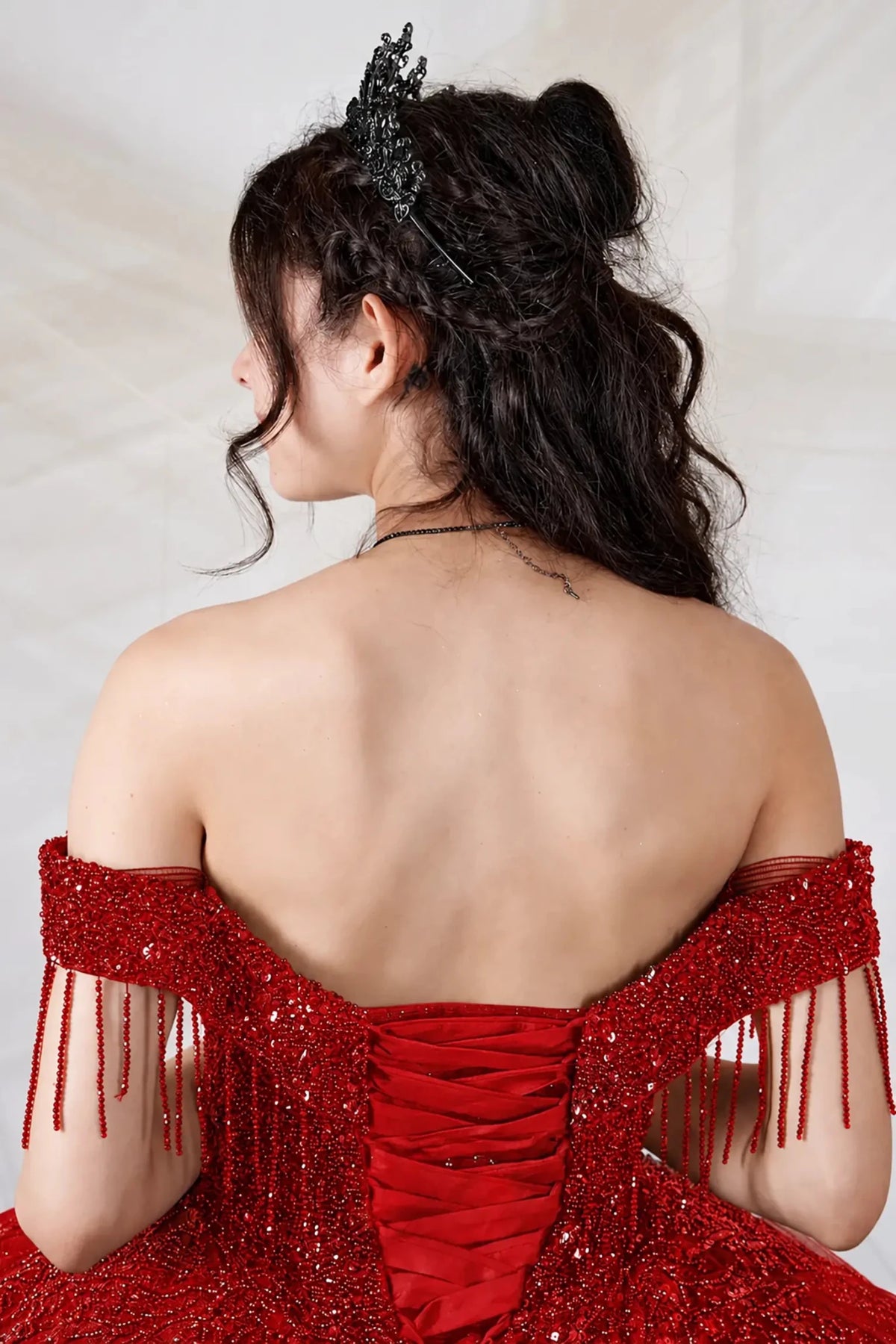 Red quinceañera ball gown with rhinestone beaded bodice, tiered ruffle hem and glitter tulle skirt
