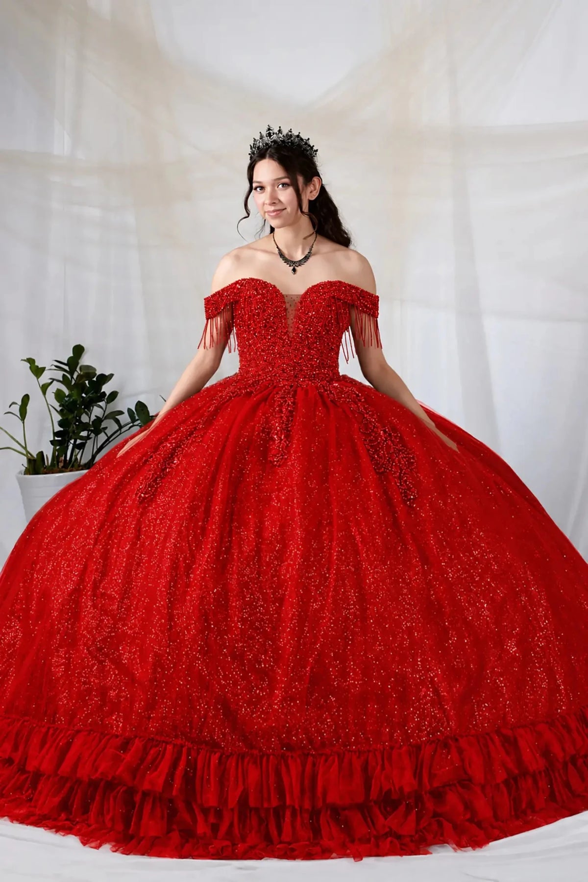 Red quinceañera ball gown with rhinestone beaded bodice, tiered ruffle hem and glitter tulle skirt