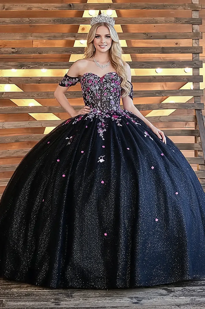Front-Facing of a woman wearing Black multicolor ball gown with floral sheer bodice basque waist and glitter tulle skirt with detachable bow