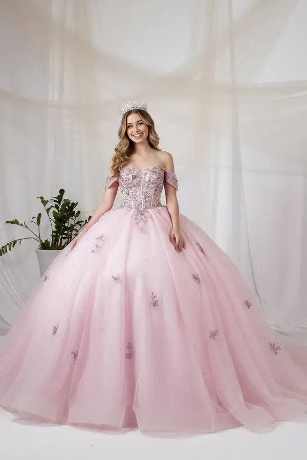 Front-Facing of a woman wearing Blush multicolor ball gown with floral sheer bodice basque waist and glitter tulle skirt with detachable bow