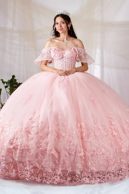 Front-Facing of a woman wearing Blush ball gown with sheer off-shoulder flounce sleeves 3D butterfly accents and sparkling tulle skirt