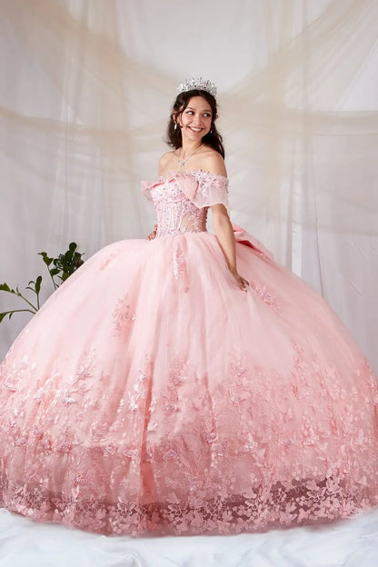 Side View of a woman wearing Soft pink gown with sheer bodice butterfly embellishments and layered airy skirt
