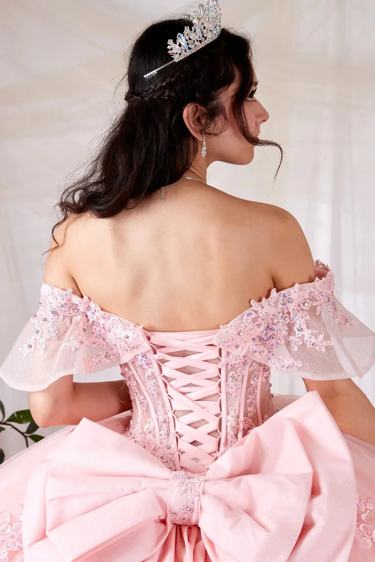 Back Close-Up of a woman wearing Back detail of blush gown showing smooth finish layered tulle and refined stitching