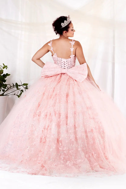Back-Facing of a woman wearing Blush formal gown featuring structured back flowing glitter tulle skirt and soft silhouette