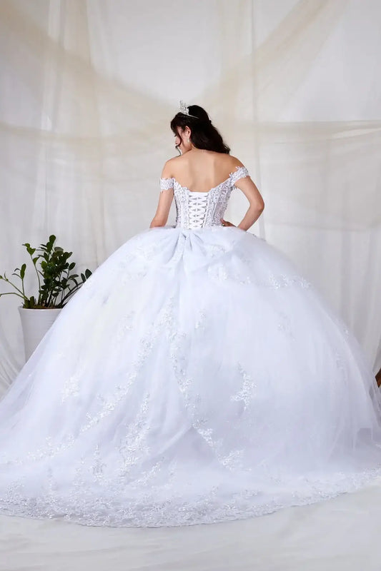 Back-Facing of a woman wearing White formal gown featuring bow detail trailing skirt and soft silhouette