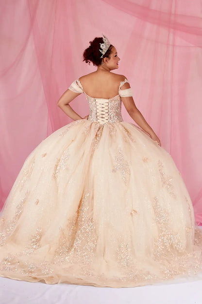 Back-Facing of a woman wearing Champagne formal gown featuring bow detail trailing skirt and soft silhouette