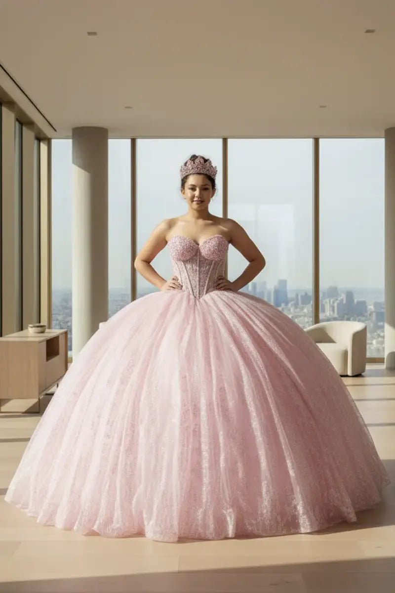 Front View of a woman wearing Bright pink gown with lace bodice detailing strapless neckline and airy skirt design