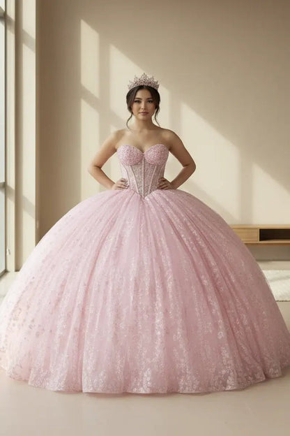 Front View of a woman wearing Bright pink gown with lace bodice detailing strapless neckline and airy skirt design