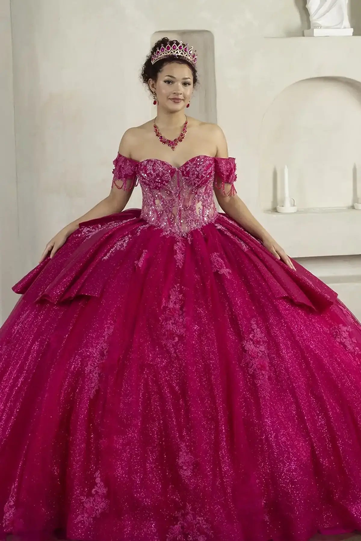 Front-Facing of a woman wearing Fuchsia ball gown with off-shoulder 3D butterfly design sweetheart neckline embroidered bodice and glitter tulle skirt