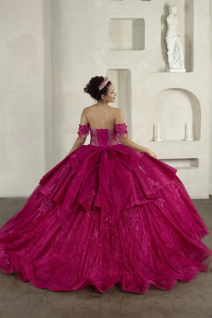 Back-Facing of a woman wearing Fuchsia formal gown featuring structured back ruffled skirt and trailing tail