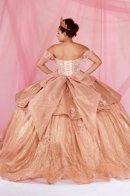 Back-Facing of a woman wearing Rose gold formal gown featuring lace-up back ruffled skirt overlay and chapel train
