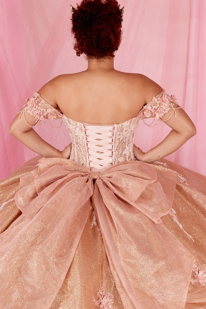 Back Close-Up of a woman wearing Back detail of rose gold gown showing lace-up closure layered tulle and extended train