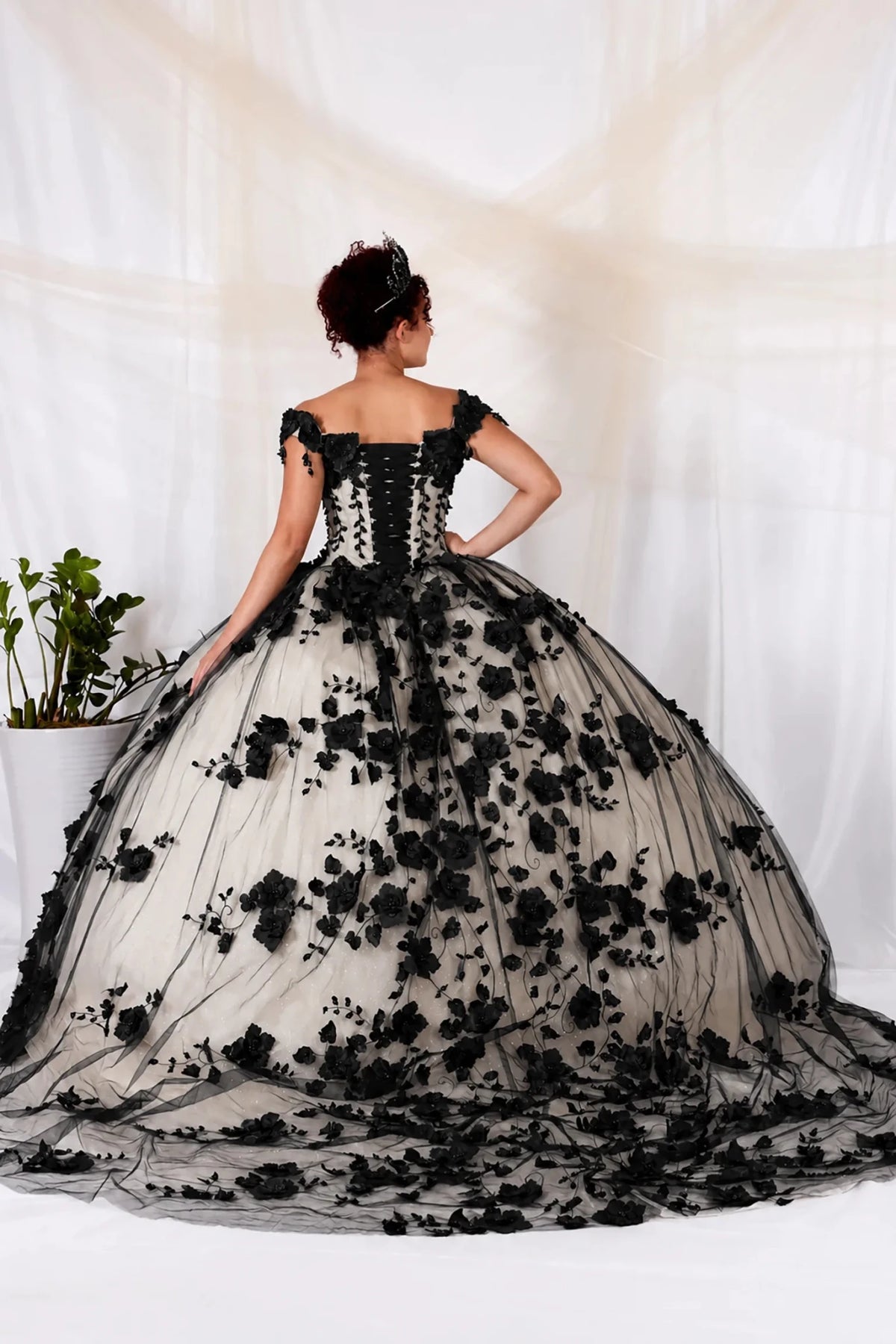 Black quinceañera ball gown with 3D floral applique, lace‑up back and layered train