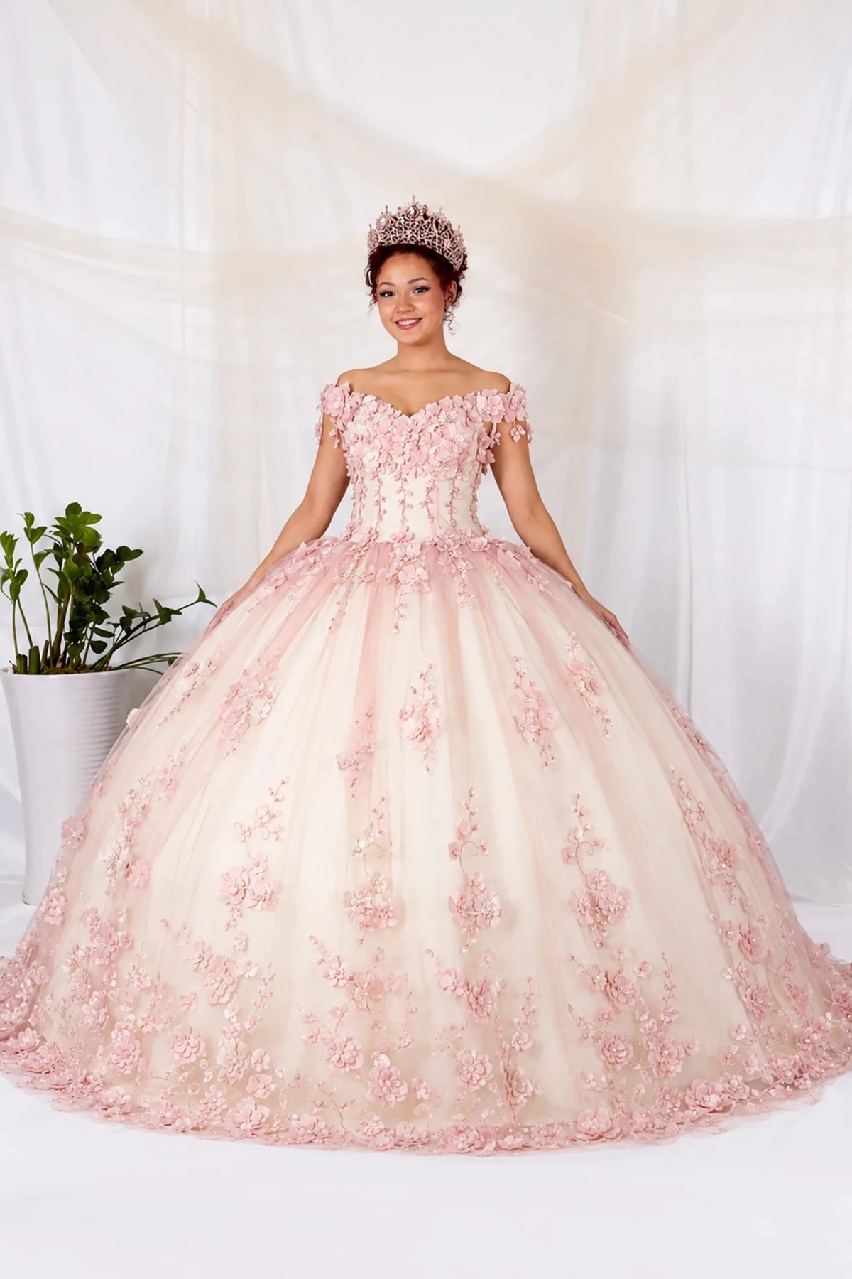 Pink quinceañera ball gown with off‑shoulder neckline, 3D floral applique and elegant long tail design
