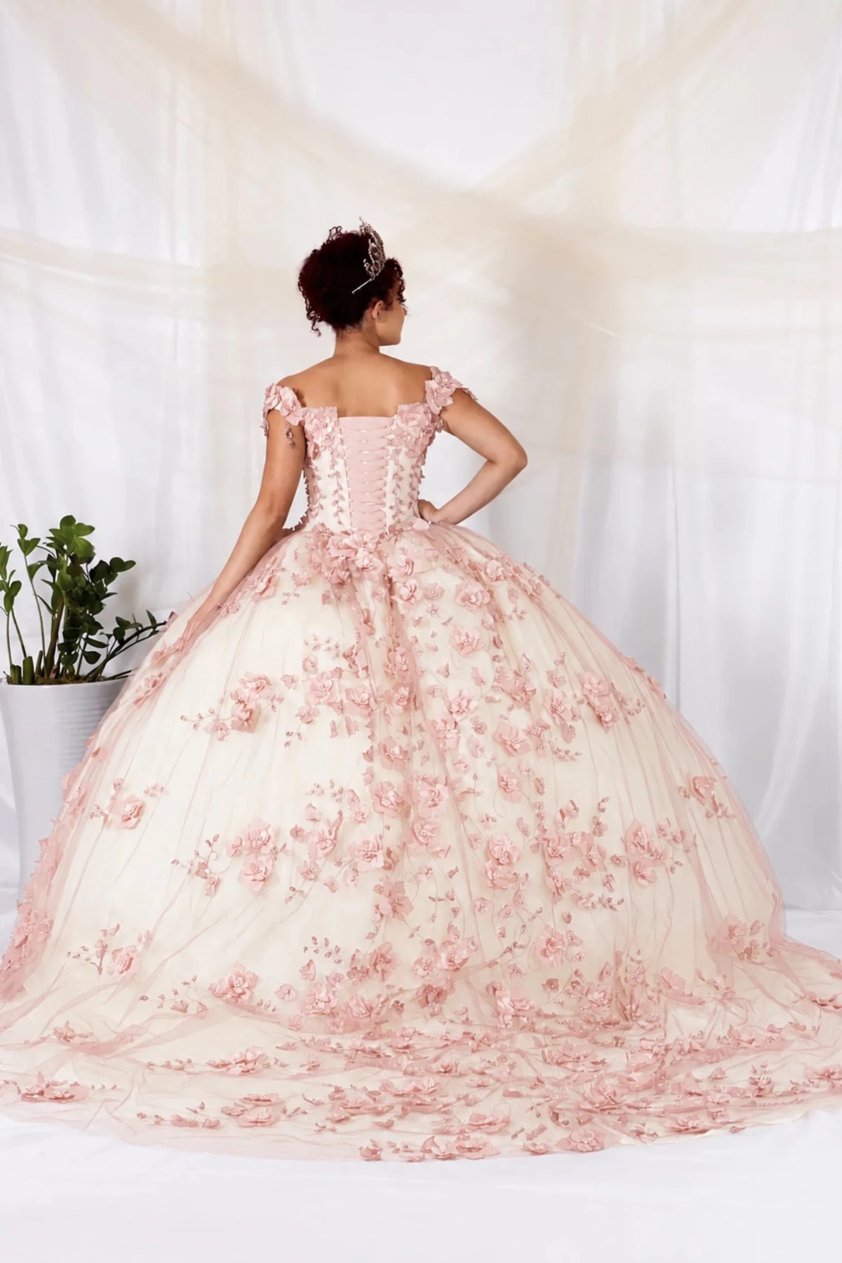 Pink quinceañera ball gown with off‑shoulder neckline, 3D floral applique and long train