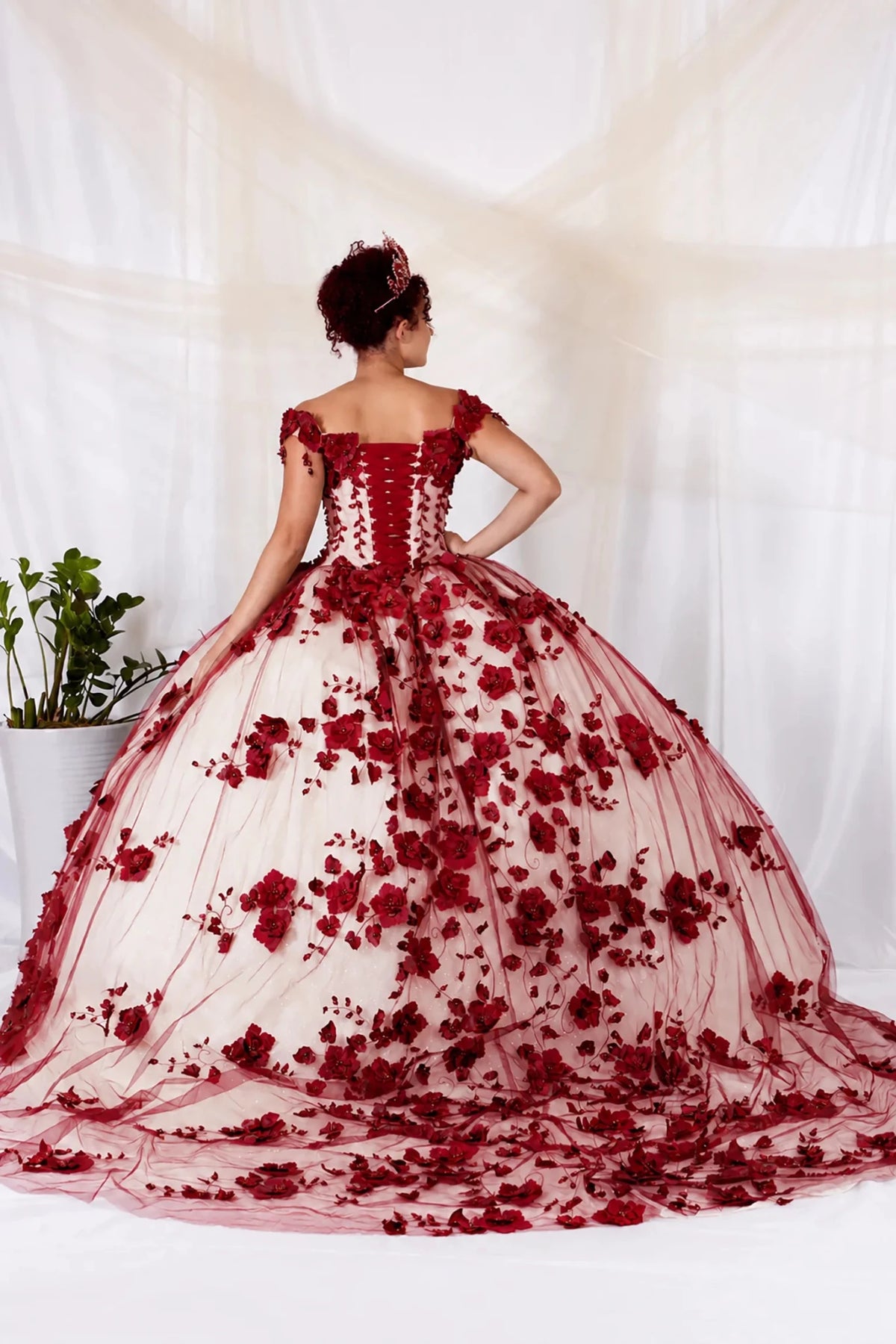 Burgundy quinceañera ball gown with 3D floral applique, off‑shoulder neckline and long train