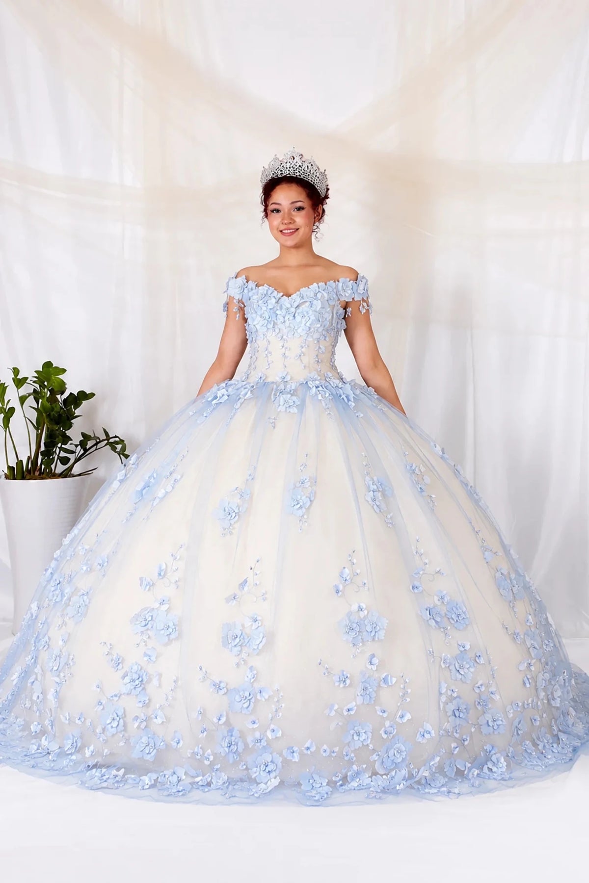 Light blue quinceañera ball gown with off‑shoulder neckline, floral applique and long train
