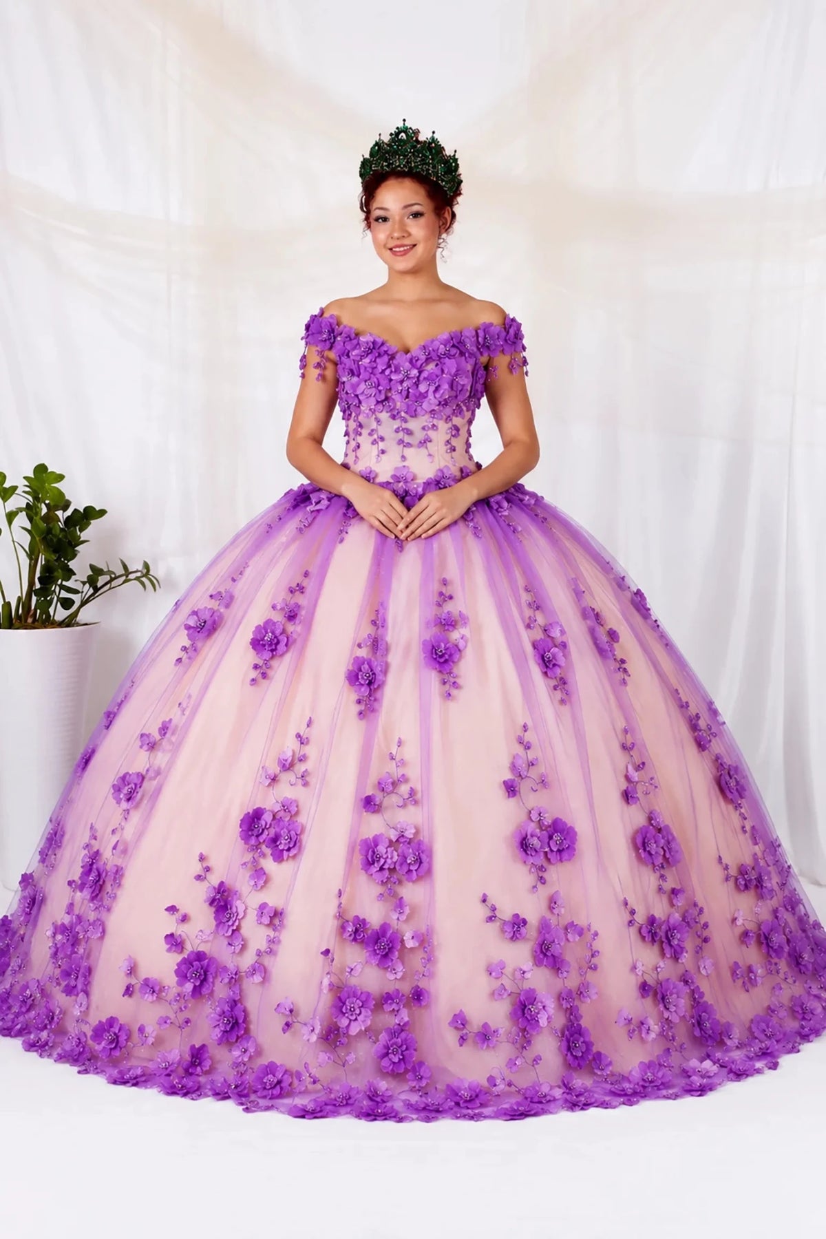 Purple quinceañera ball gown with off‑shoulder neckline, 3D floral applique, layered train and champagne tulle base