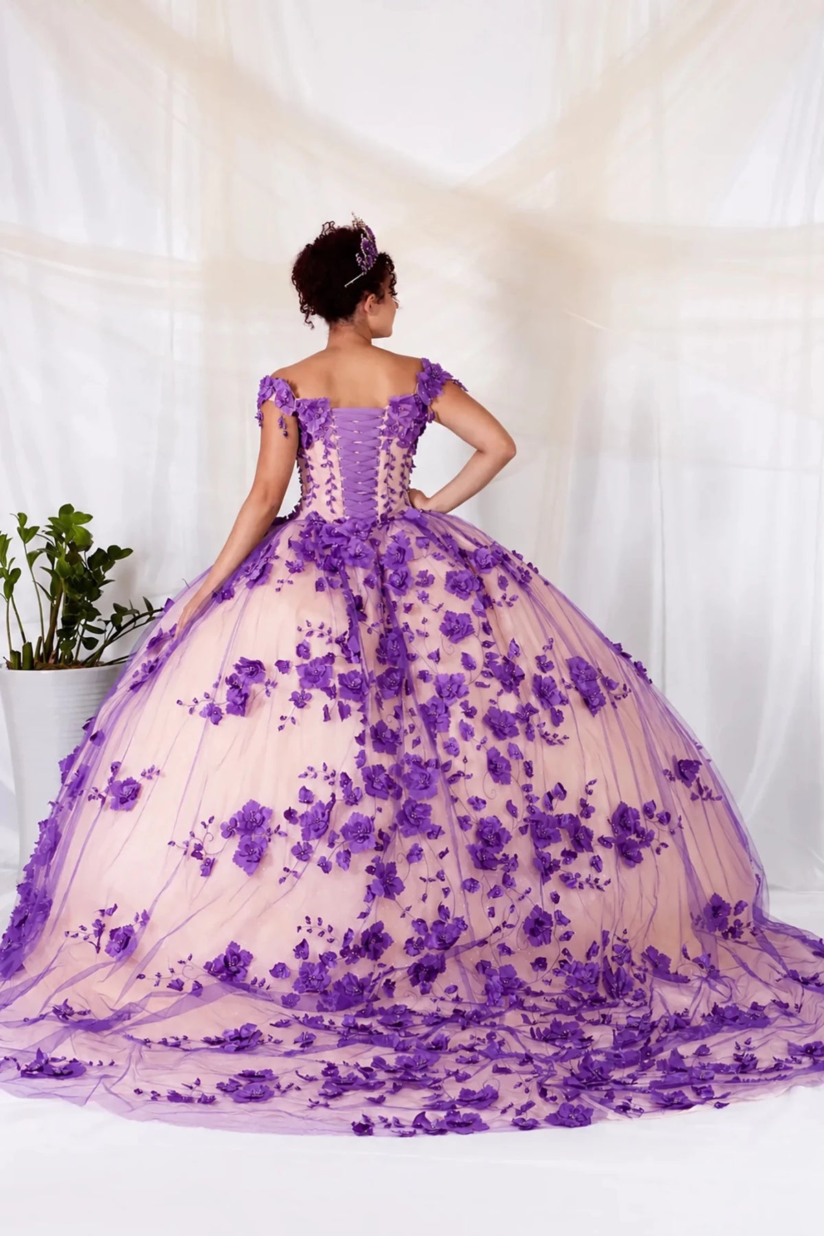 Purple quinceañera ball gown with off‑shoulder neckline, 3D floral applique, lace‑up corset and layered train