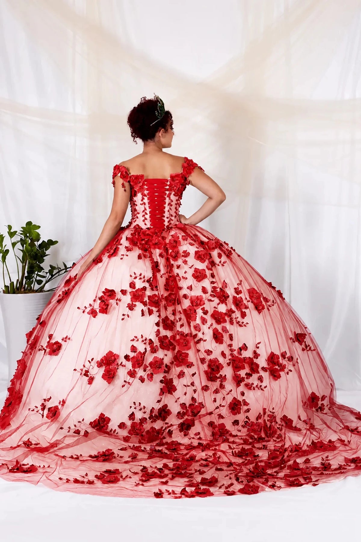 Red quinceañera ball gown with off‑shoulder neckline, 3D floral applique, lace‑up back and long train