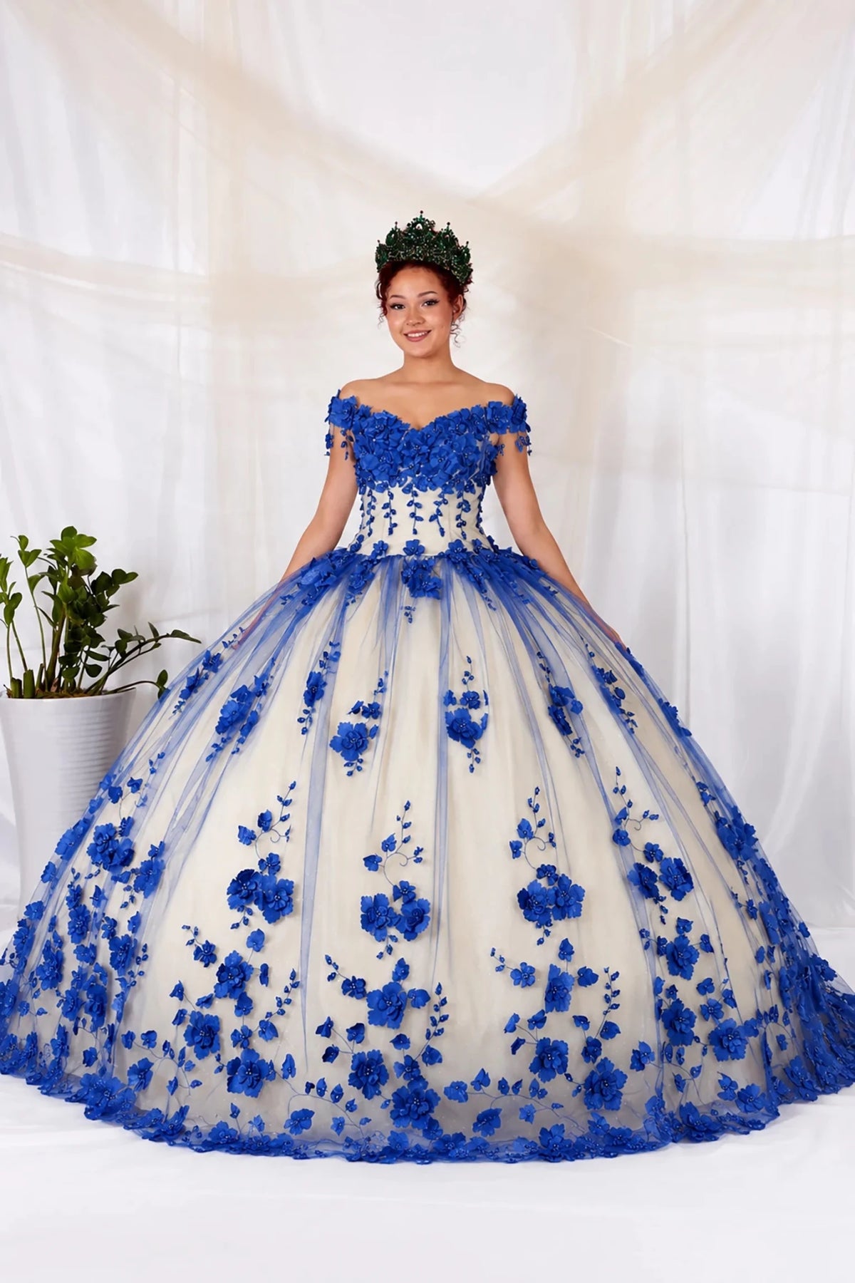 Royal blue quinceañera ball gown with off‑shoulder neckline, 3D floral applique over cream tulle and long train