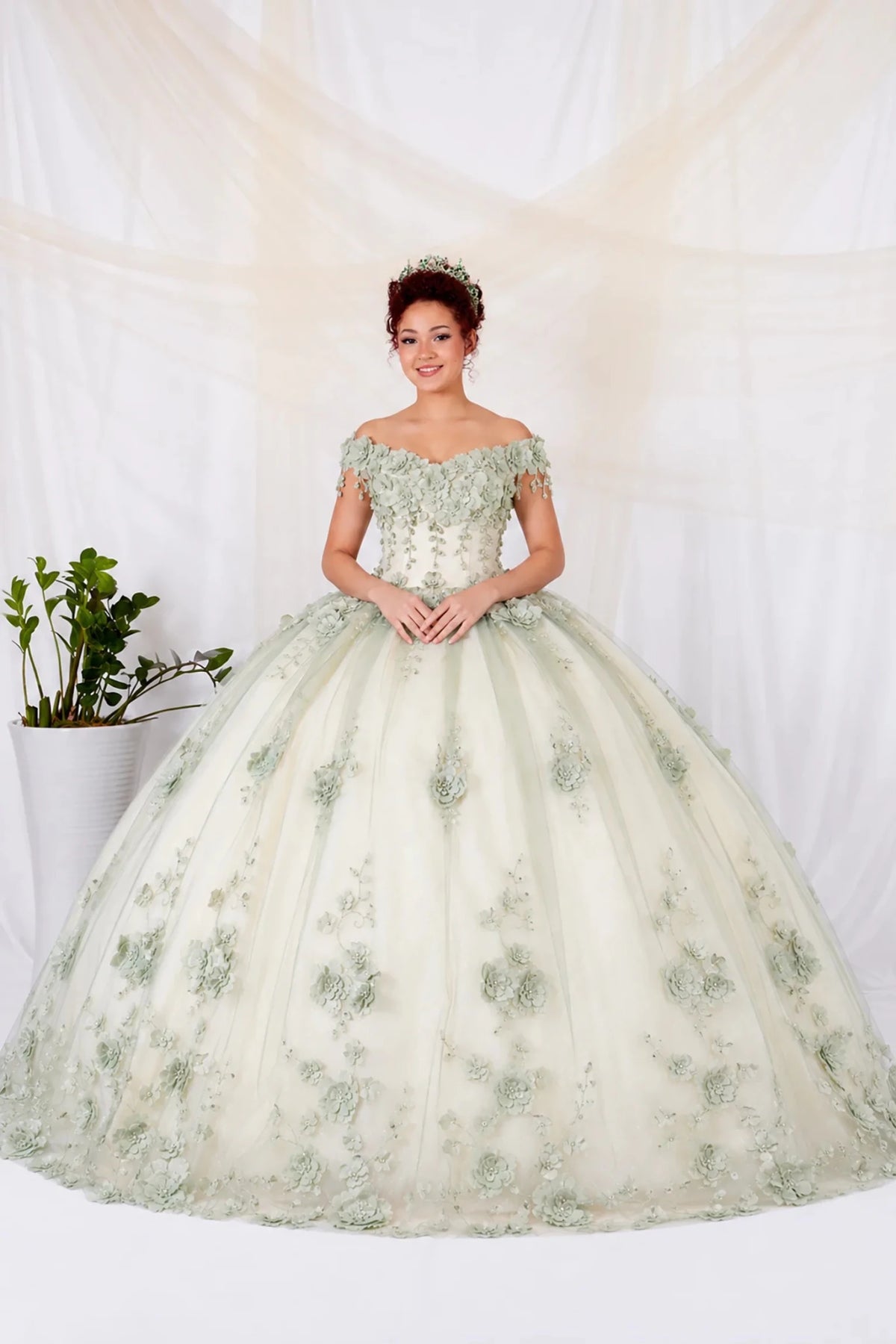 Sage quinceañera ball gown with off‑shoulder neckline, floral applique and long train over ivory tulle
