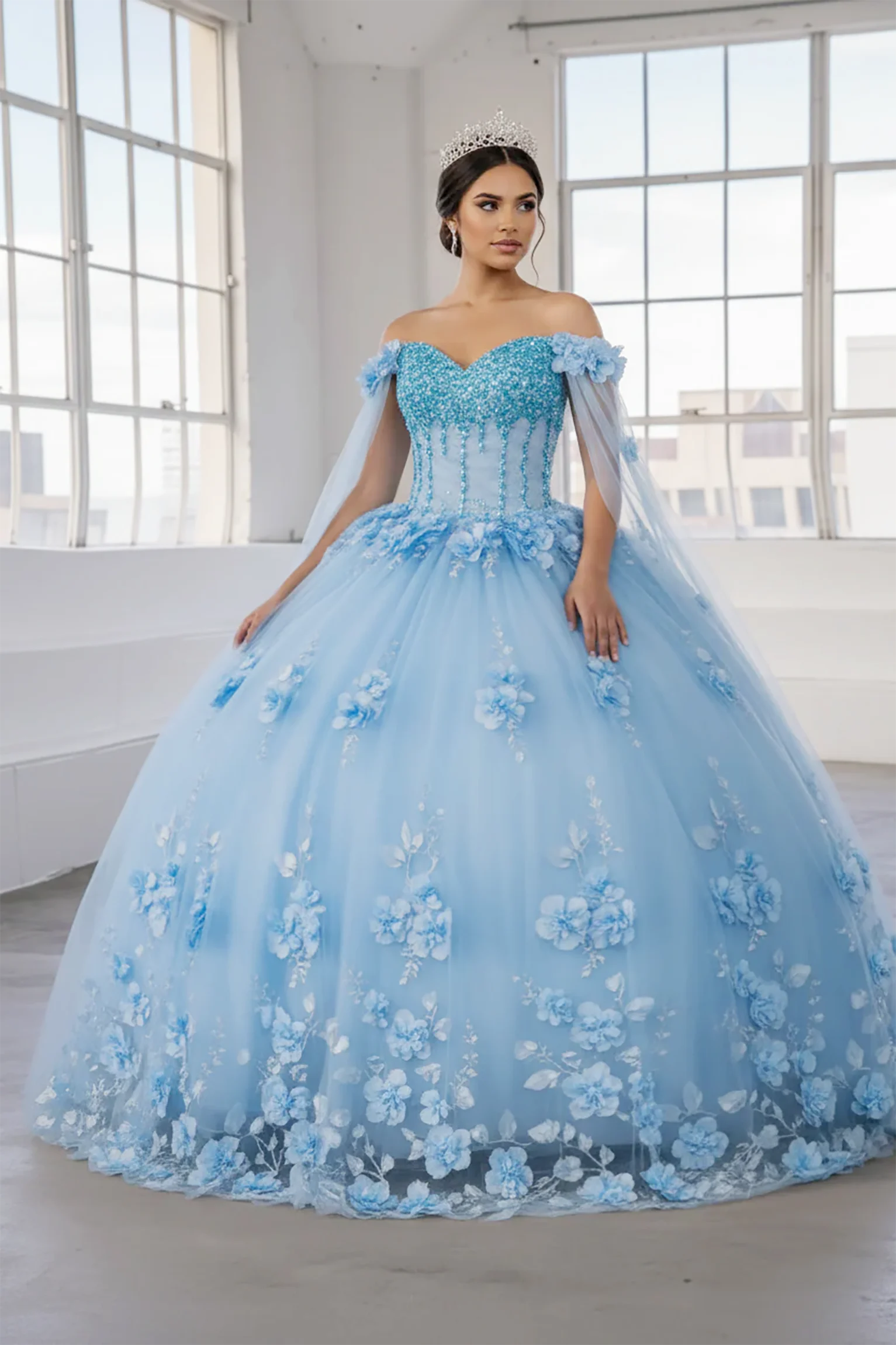 Front-Facing of a woman wearing Light blue ball gown with two-tone design floral embellishment and removable shoulder cape with flowing skirt