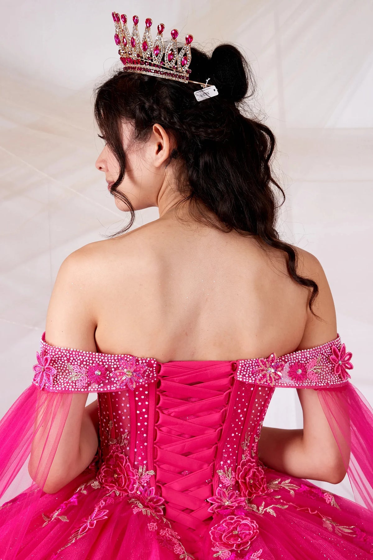 Hot pink quinceañera ball gown with lace‑up back, sheer lace bodice and 3D floral applique