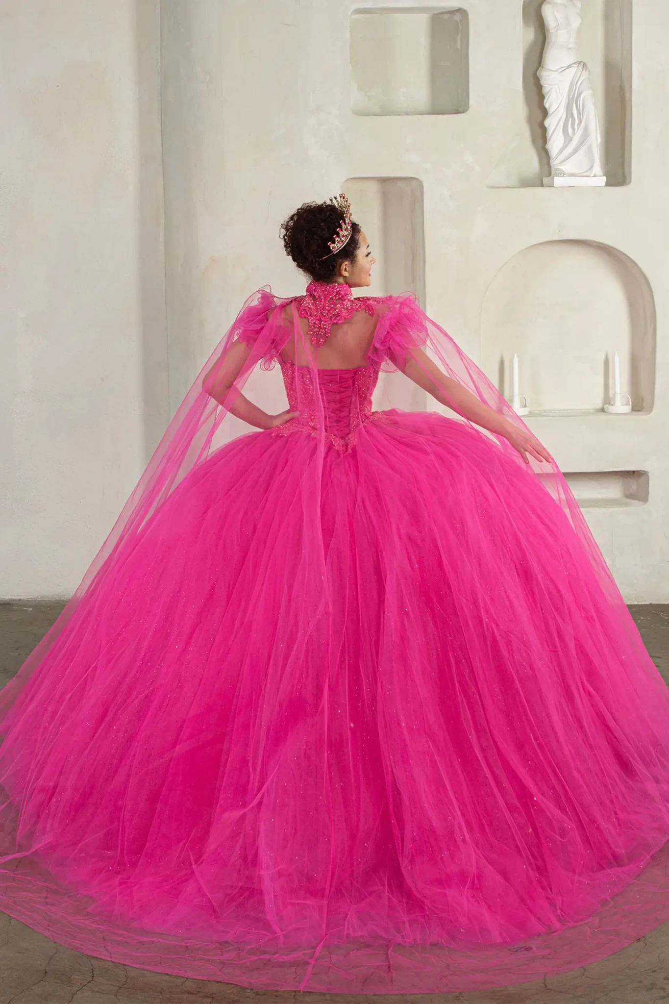 Fuchsia quinceañera ball gown with removable ruffle sleeves, beaded bodice, glitter tulle and detachable cape