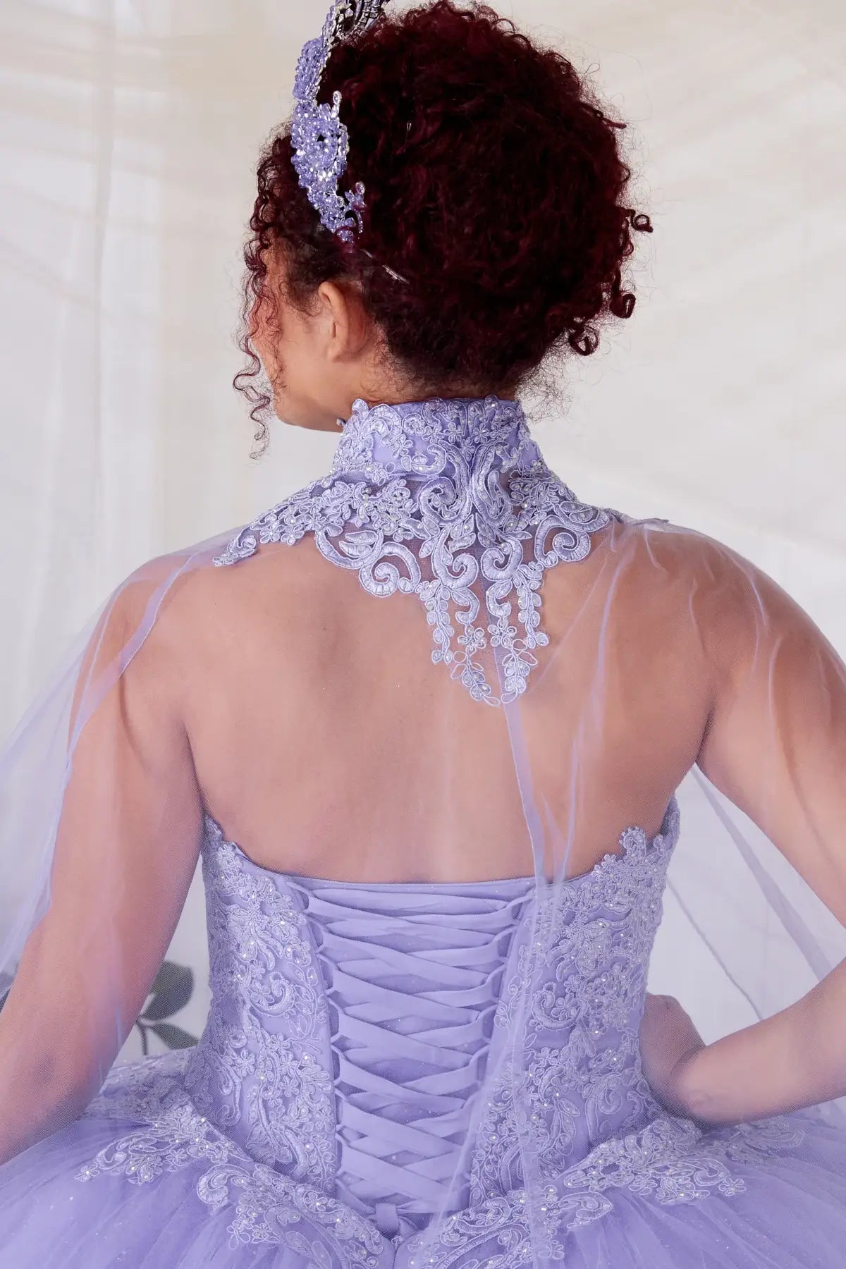 Lilac quinceañera ball gown with removable ruffle sleeves, beaded bodice, glitter tulle and flowing cape