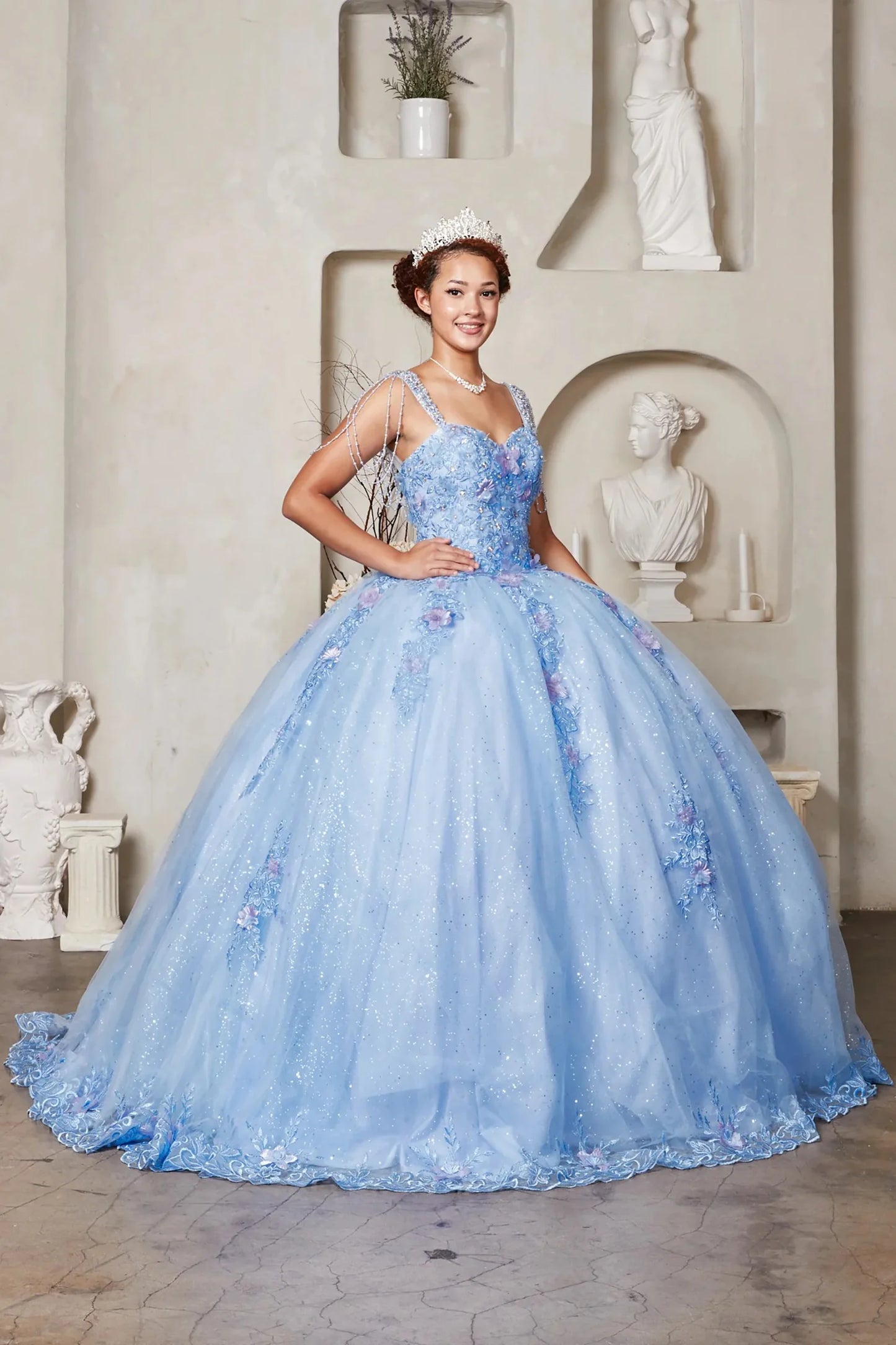 Blue quinceañera ball gown with sweetheart corset bodice framed by bead-fringed cap sleeves